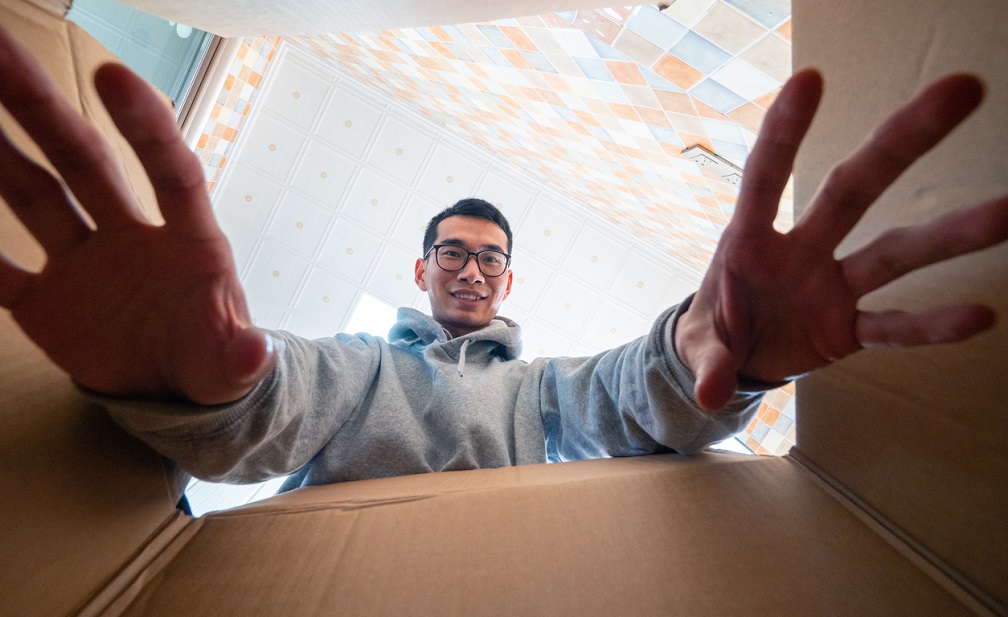 Man opening and reaching into a delivery box